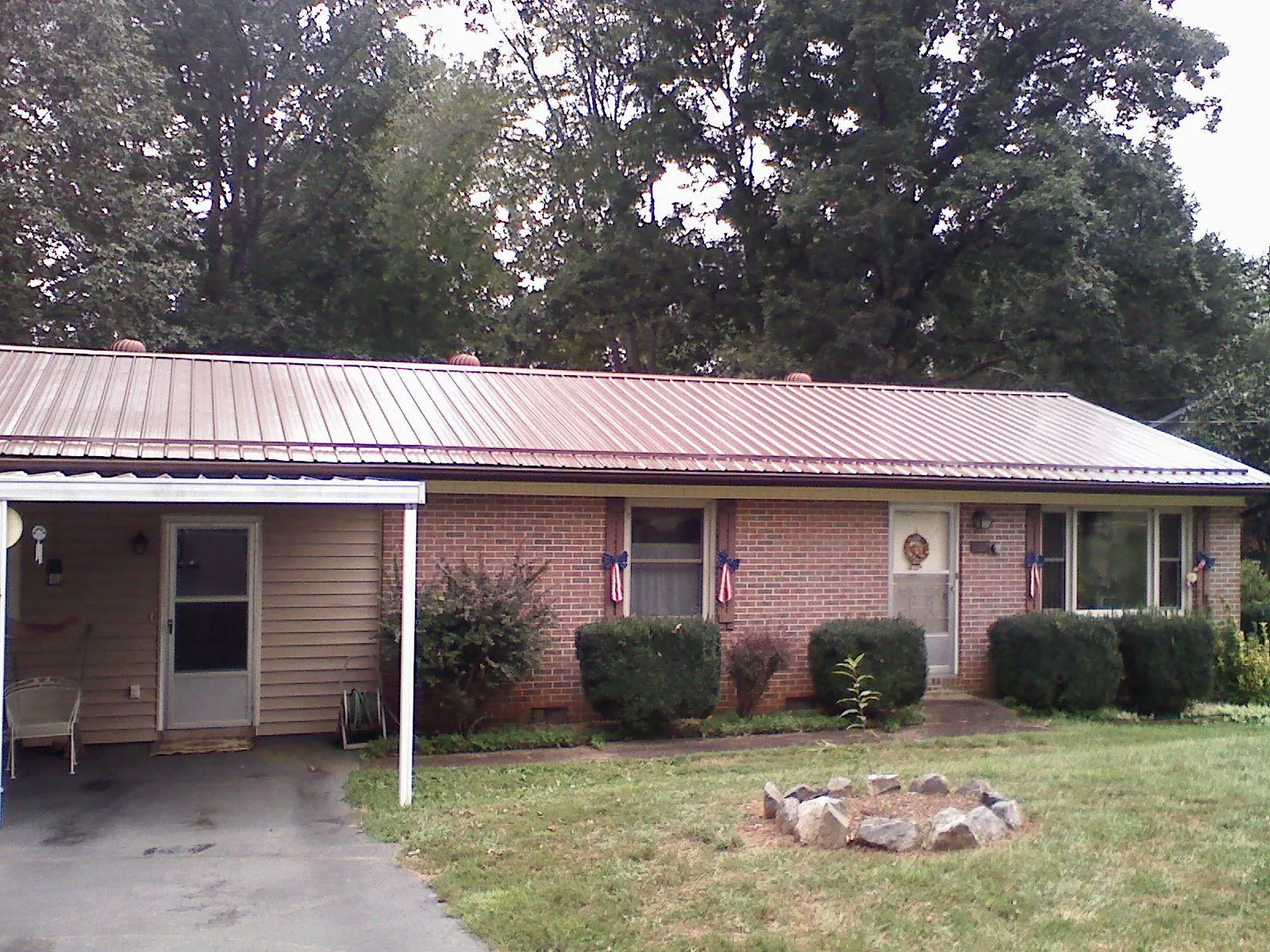 Bronze metal roof and carport on a brick ranch home — Roof Repair work by our crew in Sullivan